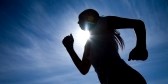 9131658-female-runner-silhouette-against-the-blue-sky-and-sun